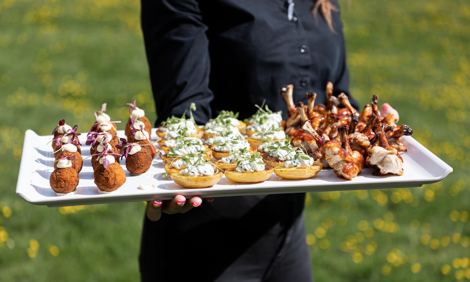 Canapes served by a waitress outside 