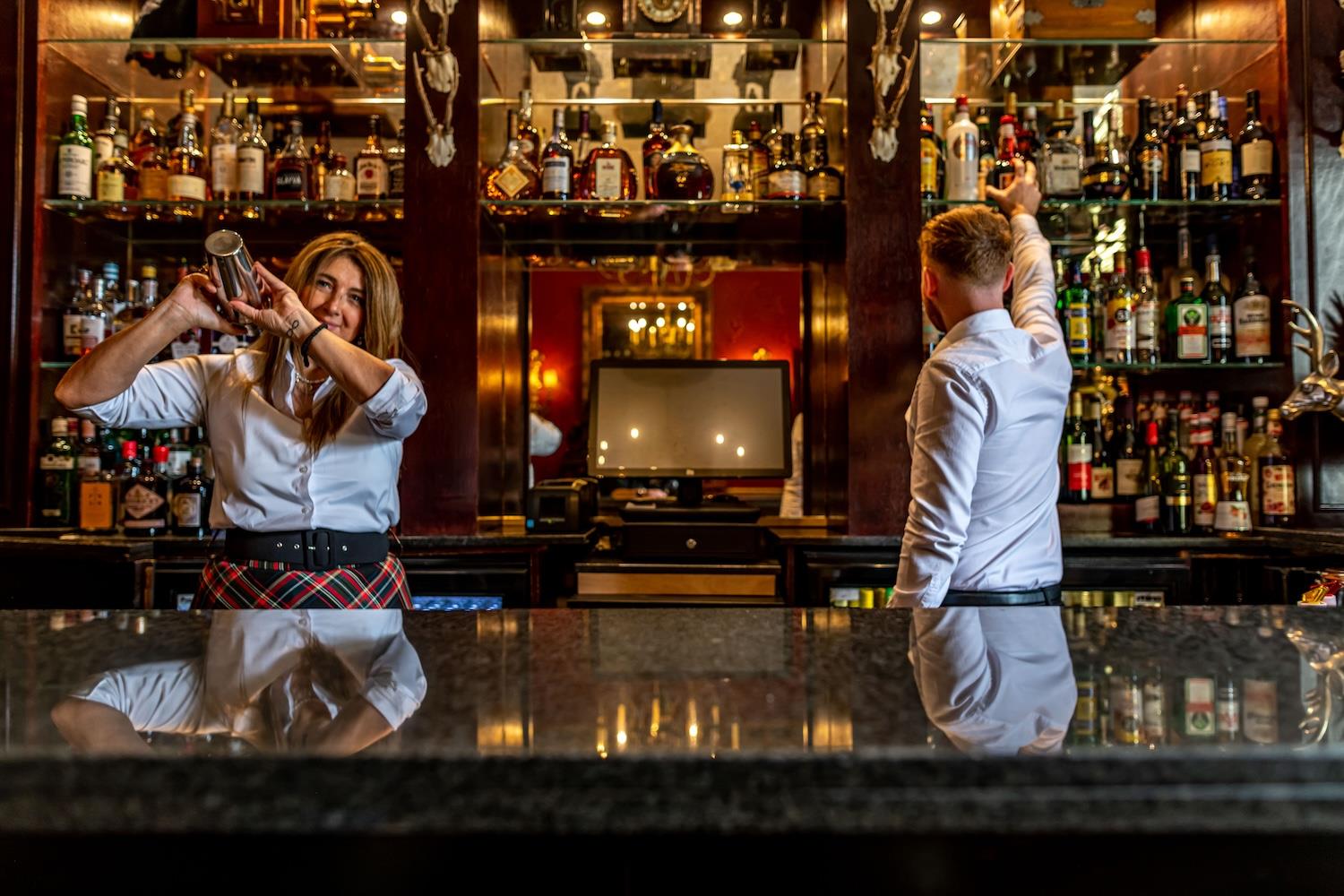 Barmen serving cocktails at the bar