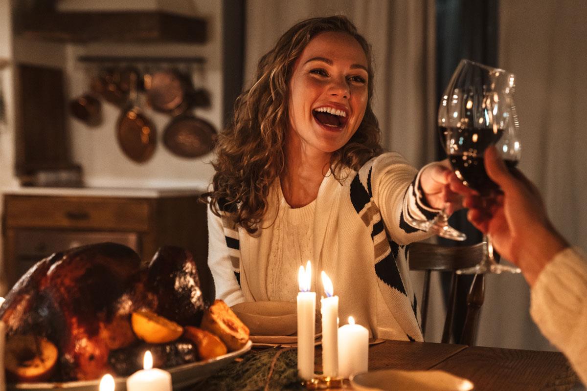 Smiling woman at party, turkey on table