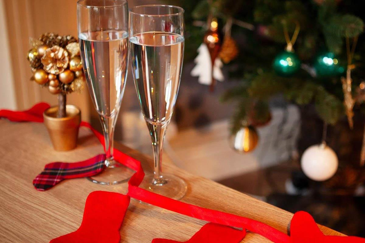 champagne glasses on table with christmas decorations